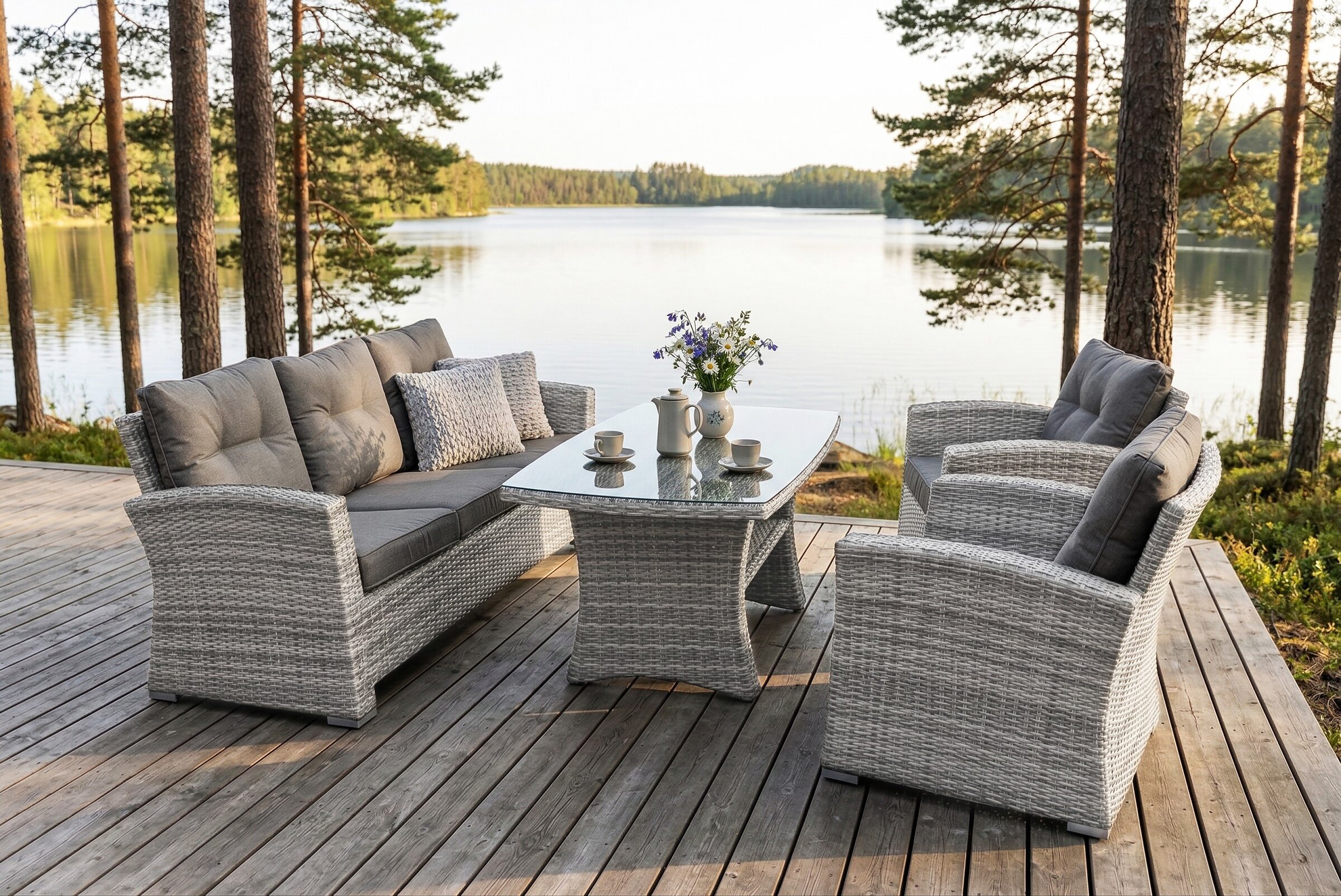 Product render of grey outdoor furniture on a lakeside terrace