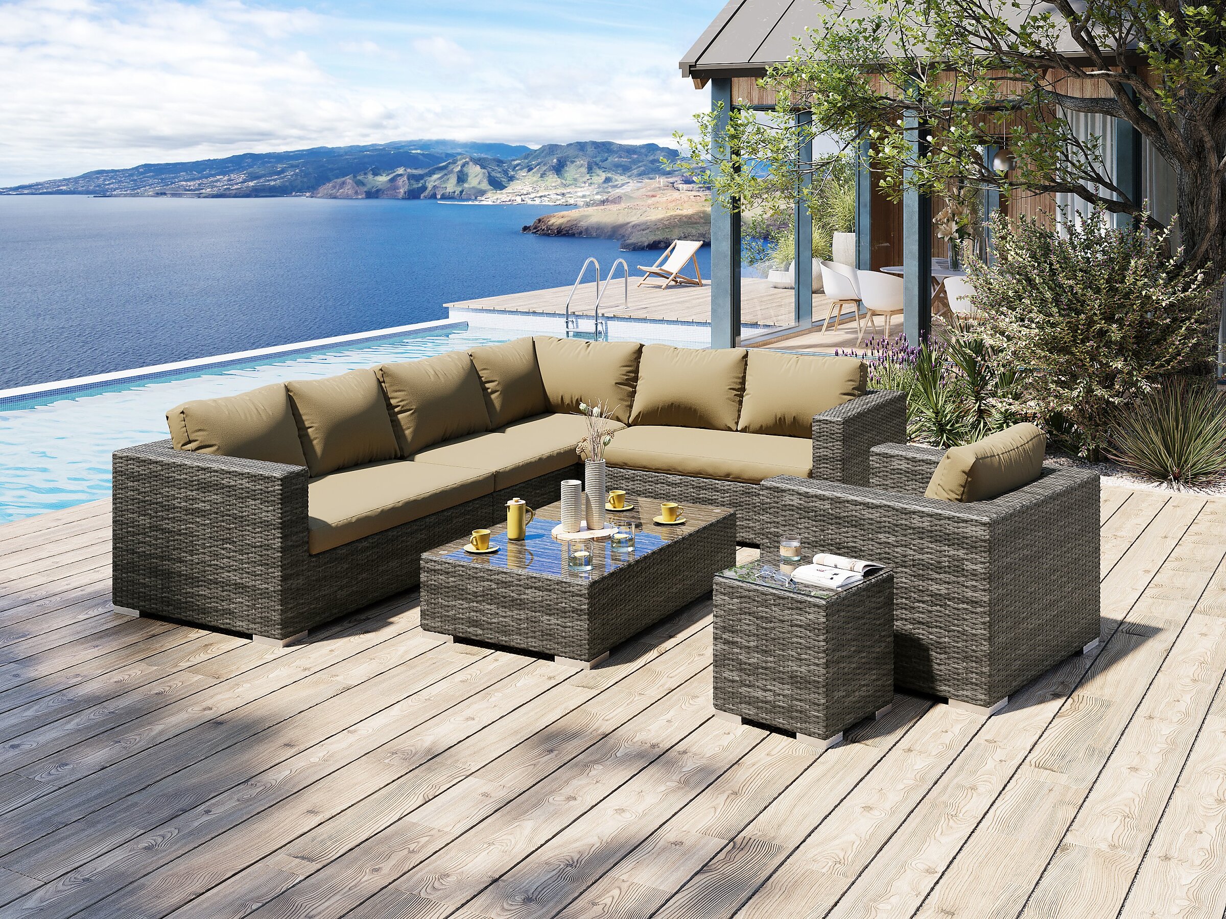 Product visualisation of the large Moonlight grey wicker outdoor corner sofa set with beige cushions, an armchair, and tables on a wooden terrace by a pool with a sea view
